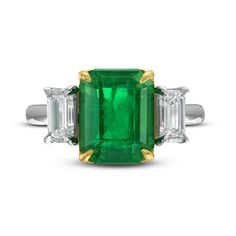 A three stone ring featuring a 3.87 carat green emerald, accompanied by emerald cut diamond side stones weighing a total of 1.05 carats, set in platinum and 18 karat yellow gold. Vintage Gold Engagement Rings, Smaragd Ring, Emerald Wedding Rings, Three Stone Ring, Ring Ideas, Wedding Vibes, Emerald Engagement, Rose Engagement Ring, 18k Gold Ring