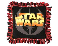 the star wars logo is shown on a black square pillow with red tassels