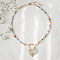 Millefiori heart carabiner necklace is such a cute and light-weight beaded custom charm necklace. In this colorful necklace, I have paired small (4 mm) millefiori glass beads with a 14k gold plated heart-shaped carabiner lock and your choice of charms. The carabiner lock opens so you can also add your favorite charms! The length of the necklace is 16 inches, with 2 inches extension chain so you can adjust the necklace between 16 and 18 inches (40 - 46 cm). Gold-plated and stainless steel.  Here's how it works: 1. Take a look at my charm options and choose the ones that you like.  2. Choose in the drop-down menu the total number of charms that you want in your necklace.  Write in the "Add your personalisation" field the numbers of the charms you want in your necklace (for example 12F, 16, 4 Heart Carabiner, Bracelet Making Tutorial, Carabiner Necklace, Custom Charm Necklaces, Jewelry Colorful, Colorful Necklace, Lock Necklace, Necklace Charms, Custom Charms