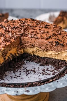 there is a chocolate cake on the plate with one slice taken out of it and another piece missing