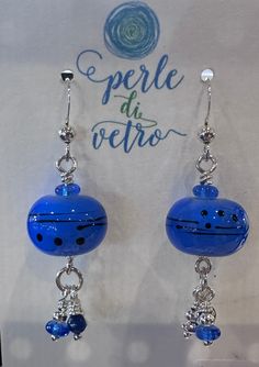 the earrings are blue and have beads on them