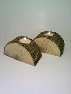 two wooden slices with candles in them