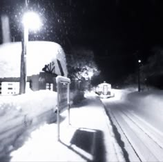 a black and white photo of a snowy street