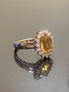 DeKara Designs Classic Metal- 14K Yellow Gold, .583. Stones- 1 Oval Imperial Topaz 3.50 Carats, 16 Round Diamonds G Color VS1 Clarity 0.55 Carats. Size- Choose Your Size, from 4-12. Please allow three to five working days for me to ship out your ring. I will start on making your ring as soon as transaction has been processed. Classic 14K yellow gold Art Deco influenced halo Imperial Topaz diamond engagement ring. The center stone is a whopping prong set 3.15 fiery oval shaped Peach colored beaut Wedding Rings With Citrine In Baguette Cut, Oval Brilliant Cut Yellow Sapphire Rings, Oval Yellow Sapphire Rings With Brilliant Cut, Brilliant Cut Oval Yellow Sapphire Rings, Citrine Baguette Cut Wedding Rings, Baguette Cut Citrine Wedding Rings, Wedding Topaz Ring With Baguette Cut, Luxury Gold Gemstones For Wedding, Baguette Cut Topaz Ring For Wedding