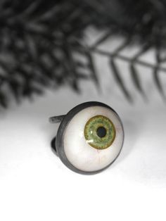 I only have eyes for you. Genuine prosthetic green eye set in hand-forged and blackened sterling silver. Each eye has been handcrafted in prothesis resin by a professional ocularist. Green eyes only. Some are more bloodshot than others and I choose them at random; please contact me if you have a preference. Sizes 3-13 You will not be receiving the exact piece in the photo but one that I have created especially for you. Please allow 2-4 weeks production time and see my FAQ for information about s Prosthetic Eye, Eyeball Ring, Green Eye, Eye Ring, Silver Bars, Green Onyx, I Choose, Hand Forged, Green Eyes