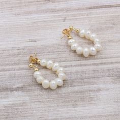 "These beautiful earrings are handcrafted with freshwater cultured white pearls. They have a high lustre, making them perfect for any occasion. The simple design is perfect for everyday wear, and the delicate pearls add a touch of elegance. Whether you're dressing up for a special occasion or just accenting your everyday look, these earrings are a must-have. + Genuine freshwater cultured baroque pearls. High luster and handpicked. Each pearl is unique. Directly sourced from origin of production. Small Hoop Pearl Earrings, Pearl Pendant Hoop Earrings Gift, Gift Pearl White Hoop Earrings With Pearl Chain, Pearl White Hoop Earrings With Pearl Chain For Gift, Pearl White Hoop Pearl Earrings, Pearl White Pearl Hoop Earrings, White Pearl Charm Hoop Earrings, Pearl White Hoop Earrings, Hoop Pearl Pendant Earrings As Gift