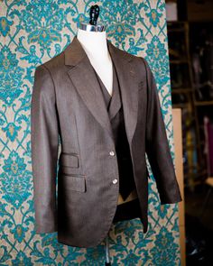 "ABOUT THIS STYLE: The style features a 1930s style jacket with a low gorge and a ticket pocket, a double-breasted notch collar vest, and a high-waisted pant with an extended waistband tab. With all of our designs, we look backward across the great history of menswear and try to bring forward is best and most fresh from the past, discarding what does not speak to our present age, but retaining all of the traditional craftsmanship and quaility. The suit is made from a vintage style herringbone su Classic Double Breasted Suit With Pockets, Classic Semi-formal Double Breasted Suit With Pockets, Semi-formal Three-piece Suit With Notch Lapel And Welt Pockets, Semi-formal Classic Double Breasted Suit, Business Three-piece Suit With Lapel Collar And Pockets, Classic Tailored Tuxedo With Pockets, Tailored Three-piece Suit With Lapel Collar And Pockets, Fitted Double-breasted Three-piece Suit With Single Button, Three-piece Suit With Notch Lapel For Tailoring