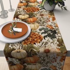 a table topped with a white plate covered in pumpkins