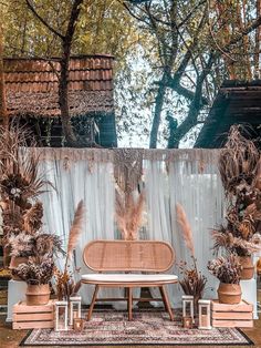 an outdoor stage set up for a wedding ceremony with tall grass and pamodia