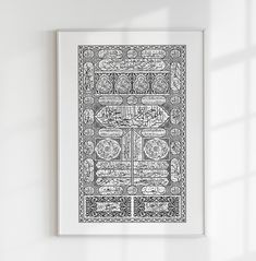 a black and white art print hanging on a wall