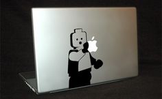 an apple laptop with a sticker of a man holding a cell phone in his hand