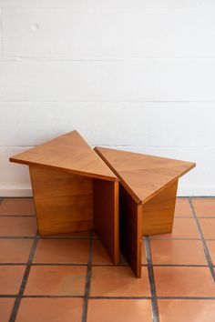 a wooden table sitting on top of a tiled floor