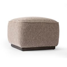 the foot stool is made out of fabric and has a wooden base, with an uphol