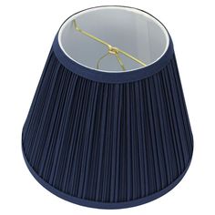 a dark blue lamp shade with a gold metal hook on the end and a white background