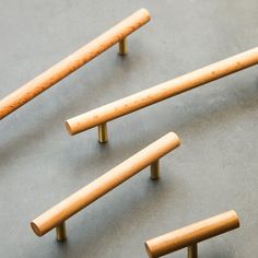 four wooden dowks are lined up on the floor and ready to be used as furniture pulls