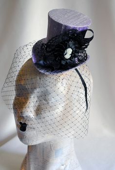 This victorian goth mini top hat is a simple yet elegant piece.It is covered with black silk shantung and adorned with black satin ribbon in a vertical half bow, vintage black cotton lace in a rosette, pleated satin ribbon, which forms an oval frame for a beautiful black and white victorian profile cameo. Choose between with or without black veil. Also available in a white and black combination: https://www.etsy.com/bizarrenoir/listing/166826619/gothic-mini-top-hat-in-purple-velvet?ref=shop_home Gothic Costume Hat With Round Crown For Costume Party, Gothic Party Hat For Halloween, Black Gothic Mini Hats For Costume Party, Gothic High Crown Costume Accessories For Party, Gothic Halloween Party Hat, High Crown Halloween Costume Hat For Party, Halloween Party Costume Hat With High Crown, Handmade Gothic Costume Hats And Headpieces For Parties, Handmade Gothic Costume Hats And Headpieces