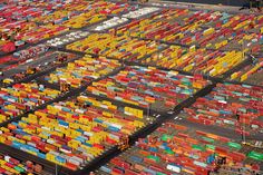 an aerial view of a large container yard with many containers stacked on top of each other