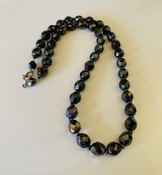 This classic nice quality 18 inch 7mm faceted jet black bead necklace is a classic closet basic. The faceted beads have seed bead spacers and wire strung smaller beads near the clasp to keep the back from being bulky. The necklace is sturdy with a gold tone lobster claw closure. The necklace is a classic inches long. This necklace is a great closet basic in wonderful vintage condition. The beads have a bright carnival sheen. I specialize in finding fun wearable vintage jewelry. Please browse my Stone Bead Necklace, 80s Theme Party, Classic Closet, Black Bead Necklace, Stone Beaded Necklace, Copper Bracelet, Bright Gold, Faceted Bead, Black Beads