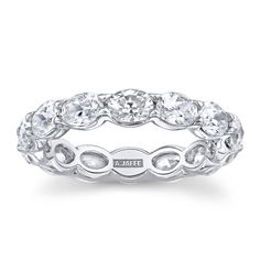 a white gold wedding band with oval cut diamonds