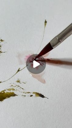 someone is using a brush to paint the image on paper with watercolors and acrylic