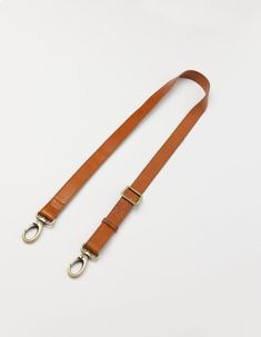 The details on this strap are made from our Stromboli leather which has a slightly textured appearance. Shorter than our regular webbing straps, with a maximum length of 115cm, this strap features our brass dog hooks and can be used on any O My Bag. Our personal favorite is the Beck's Bum Bag x leather strap combo. Minimum length: 67cm and Maximum length: 115cm. OMB-leatherbumbagstrapbs Adjustable Leather Shoulder Bag For Everyday, Rectangular Leather Bag Strap With Leather Handles, Rectangular Leather Bag Strap With Handles, Leather Bag Strap With Leather Handles For Everyday, Classic Dark Tan Shoulder Bag With Adjustable Strap, Brown Leather Bag Strap For Everyday Use, Classic Cognac Shoulder Bag With Adjustable Strap, Adjustable Bag Strap With Leather Handles For Travel, Adjustable Leather Bag With Leather Strap