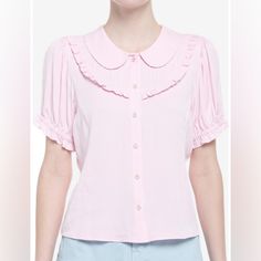 Your Outfit Will Be In Full Bloom With This Adorable Woven Button-Up! Add Something As Sweet As Cherry Blossoms To Your Wardrobe With This Pink Top, Featuring Sakura Buttons Down The Center, A Peter Pan Collar And Bib Detailing Along The Chest. Comes With Puffy Elasticated Sleeves And Princess Seams. 100% Rayon Wash Cold; Dry Low 22" Length Non Stretch Feminine Pink Collared Top, Pink Collared Top With Button Closure, Feminine Short Sleeve Shirt With Buttons, Pink Collared Top With Buttons, Feminine Tops With Peter Pan Collar And Button Closure, Summer Tops With Peter Pan Collar And Button Closure, Feminine Collared Blouse With Buttons, Feminine Blouse With Collared Neckline And Buttons, Feminine Collared Tops With Buttons