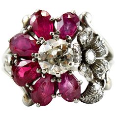 An unusual Ruby and Diamond Cluster Ring, ca. 1940s. Centring an old-cut diamond of ca. 0.85ct (ca. I/VS1), surrounded by six ruby petals, accentuated by another flower studded with diamonds. Ring size 8 (can be altered). Flower Cluster Ring, Vintage Cluster Ring, Ruby Flower, Yellow Gold Cocktail Ring, Sapphire Cocktail Ring, Antique Jewelry Rings, Flower Cluster, White Gold Set, Bridal Wedding Rings