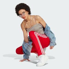 adidas Adicolor SST Track Pants - Red | Women's Lifestyle | adidas US Adidas Sporty Sweatpants For Spring, Adidas Sportswear Pants For Spring, Sporty Adidas Joggers For Spring, Sporty Adidas Logo Pants, Adidas Three Stripes Pants, Casual Adidas Joggers For Workout, Casual Adidas Logo Pants For Spring, Casual Adidas Bottoms, Spring Casual Pants With Adidas Logo