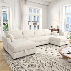 a living room with a large sectional couch and coffee table in front of two windows