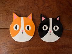 two black and white cats painted on wooden boards