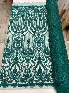 a green and white table cloth on top of a wooden floor