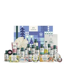 an assortment of skin care products displayed in front of a blue and white background with snowflakes