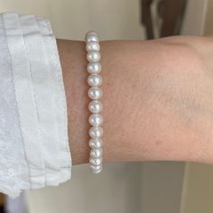 This classic pearl bracelet features AAA+ quality white medium size 5.5mm white freshwater pearls. The overall appearance is a modern minimalist display of white round pearls and sterling silver that is worthy of any occasion from casual to ultra-formal. Also available in gold filled. Freshwater pearls symbolize purity, harmony and humility. Pearls are organic gems that are officially the oldest gem coveted by man for their beauty and have been used as a trade commodity for thousands of years. Classic Everyday Beaded Bracelets With Pearl Charm, Pearl White Pearl Bracelet With 8mm Beads, Single Strand Round Beads Pearl Bracelet, Pearl White Single Strand Bracelet With Round Beads, Classic Everyday Pearl Bracelet With Pearl Charm, Elegant Hand-strung Pearl White Bracelet, Classic Adjustable Hypoallergenic Pearl Bracelet, Everyday Pearl Bracelet With Pearl Drop, Elegant White Bracelets With 8mm Beads