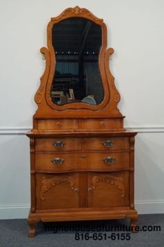 an old dresser with a mirror on top