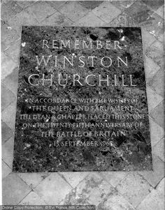 a memorial plaque on the ground in front of a wall with writing that reads, remember winton church