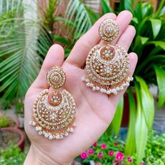 Featuring a pair of intricately handcrafted jadau chandbali earrings in 22k gold plated sterling silver. The earrings are embellished with over 350 handset precious freshwater pearls. The hanging beads are freshwater pearls. The earrings weigh 32 gms and measure 7cms x 4cms Watch Video Here 22k Gold Chandbali Bridal Earrings With Latkans, 22k Gold Chandbali Bridal Earrings, 22k Gold Chandbali Bridal Earrings As Gift, 22k Gold Chandbali Bridal Earrings For Gift, 22k Gold Chandbali Danglers With Latkans, 22k Gold Meenakari Bridal Earrings For Celebration, 22k Gold Bridal Earrings With Meenakari For Celebrations, 22k Gold Chandbali Wedding Danglers, Wedding Chandbali Danglers In 22k Gold