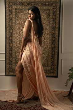 This baby peach pre-draped saree is a vision of elegance, crafted from Linen Satin fabric that glimmers with every movement. Paired with a Net blouse, the ensemble radiates sophistication and charm. The intricately hand-embroidered blouse adds a touch of glamour, making it perfect for a cocktail or reception, whether for the bride or her bridesmaids. With its timeless allure and delicate detailing, this saree is sure to captivate attention and leave a lasting impression on any special occasion.F Side Open Pre-draped Saree With Resham Embroidery For Parties, Party Side Open Pre-draped Saree With Resham Embroidery, Formal Draped Lehenga With Zari Work, Peach Lehenga With Traditional Drape For Reception, Traditional Drape Peach Lehenga For Reception, Formal Pre-draped Saree With Pallu, Floor-length Peach Choli For Reception, Elegant Draped Pink Lehenga, Party Wear Draped Lehenga With Cutdana