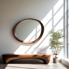 a wooden bench sitting in front of a round mirror on the wall next to a potted plant