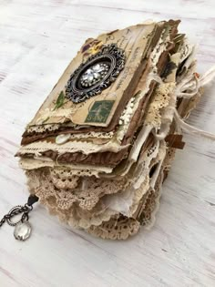 an altered book is sitting on top of a wooden table with a chain attached to it