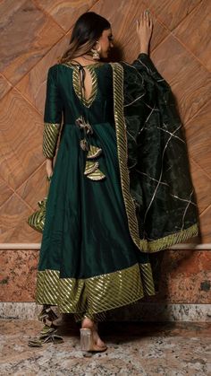 PRODUCT DESCRIPTION: Anarkali : Cotton silk Pant: Cotton silk Dupatta: Organza Color: Dark green work : Gotta lace work, allover anarkali ,pants and dupatta No. Of Components : Set of 3 Wash Care : Dry Clean Customization : Only Size and Length Of Product SKU#: 11403160GR Disclaimer: All our pieces are handcrafted in our manufacturing unit .We Ensure that our pieces are shot professionally under controlled lighting. Colours tend to be perceived differently depending on factors such as shot angle Green Anarkali Set For Navratri Designer Wear, Green Anarkali Kurta With Pallu, Designer Green Anarkali Set For Navratri, Designer Anarkali Set In Green, Green Semi-stitched Cotton Silk Sharara, Festive Green Slub Silk Lehenga, Green Anarkali Sharara In Cotton Silk, Designer Green Slub Silk Dupatta, Green Anarkali Set With Resham Embroidery In Maxi Length