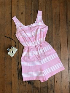 "Super cute pink cotton romper from the 1950s. This one has a metal zipper up the front and elastic at the waist for more movement.  Label: none Measurements: { xsmall - small } Bust: 34\"/35\"  Waist: 20\"-28\"  Hips: 37\" Length: 31\" Rise: 14.5\" Condition: excellent vintage condition with minor signs of wear - sold as found. washed and ready to wear  ☆Shop☆ http://www.trunkofdresses.com/" 1950s Shirtwaist Dress, Vintage Romper, Pink Romper, Womens Jumpsuits, Pink Rompers, Cotton Romper, Star Dress, Fashion Design Clothes, The 1950s