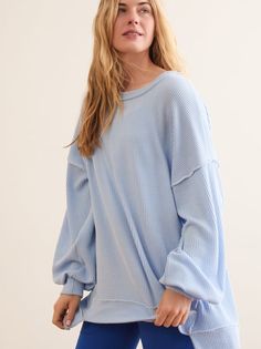 This effortless layering piece features an oversized fit, a ribbed fabrication, and buttery soft interior for the warmth and comfort you need. The exposed seam detailing and balloon sleeves instantly upgrade your athleisure look, whether heading to the studio or running errands. Blue Tops For Lounging In Fall, Casual Balloon Sleeve Sweater With Ribbed Cuffs, Casual Sweater With Balloon Sleeves And Ribbed Cuffs, Oversized Blue Ribbed Top, Comfy Solid Color Spring Tops, Comfy Spring Tops, Casual Soft Knit Tops With Balloon Sleeves, Casual Balloon Sleeve Spring Sweater, Trendy Tops With Ribbed Cuffs And Balloon Sleeves