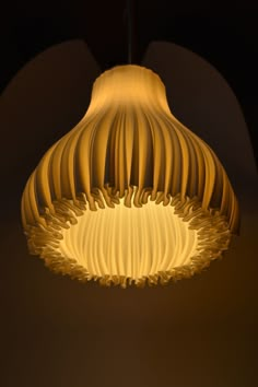 a light that is hanging from the ceiling in a room with dark walls and flooring