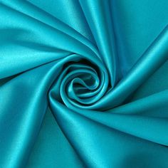 a close up shot of a blue satin fabric