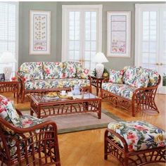 a living room filled with lots of furniture on top of a hard wood flooring