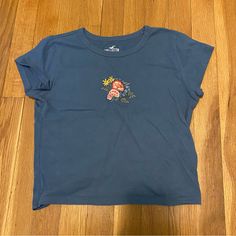 Hollister Blue Flower Embroidered Mini Baby Tee Short Sleeve Cropped T-Shirt Xs Nwot In Perfect Condition, Bought But Never Wore It So Cute But Not My Style Anymore Pm Or Comment With Questions/Offers #Hollister #Babytee #Embroidered #Flowers #Floral #Tshirt Light Blue Short Sleeve Top With Floral Embroidery, Blue Crew Neck Top With Floral Embroidery, Blue Crew Neck Tops With Floral Embroidery, Blue Floral Embroidered Crew Neck Top, Light Blue Embroidered Tops With Crew Neck, Blue Embroidered T-shirt For Summer, Casual Blue Top With Embroidered Graphics, Casual Blue Tops With Embroidered Graphics, Blue Casual Top With Floral Embroidery