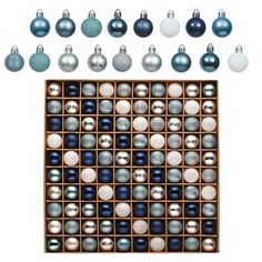 an assortment of christmas ornaments in wooden box with white and blue balls on the bottom