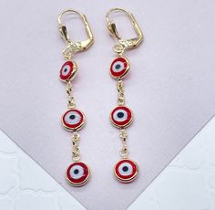 "Christmas season is a great period to give gifts. Enjoy a special collection just having you in mind. It's time to celebrate. Time to give, time to receive. Time to spread love. 18k Gold Filled Red Evil Eye Dangling Earring Our Etsy store was developed to help you find the most unique styles of modern designs, always looking for elegance and market trends. Here you will find ways to better make your jewelry through quality, seeking harmony, exclusivity and impeccable finish. Find many more styl Cheap Red Evil Eye Jewelry, Red Dangle Holiday Jewelry, Nickel Free Red Jewelry As Gift, Nickel Free Red Jewelry Gift, Nickel-free Red Jewelry For Gifts, Nickel-free Red Jewelry Gift, Red Festive Jewelry For Gifts, Red Jewelry For New Year Holiday, Red Festive Jewelry For Gift Giving