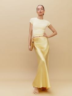 Let your skirt do the talking. Shop the Bella Silk Skirt from Reformation,  a bias cut maxi skirt with an elasticated waist. Silky Maxi Skirt, Maxi Skirt Formal Outfit, Silk Bias Skirt, Gold Slip Skirt Outfit, Yellow Silk Skirt, Champagne Silk Skirt, Silk Skirt Outfits, Long Silk Skirt Outfit, Silk Skirt Outfit Summer