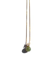 Necklace Nephrite Untreated This elegant Esther necklace features a classic pendant with a zircon centerpiece and moss-green nephrite jade. Crafted from a gold-plated box chain, this timeless necklace is perfect for any occasion and is sure to be your everyday statement piece. Natural and untreated nephrite. Made by handwork of carving and polishing. Because of the gemstones natural characteristics, each piece may vary slightly in colors and textures. Weight: 2g Bead: nephrite, diameter 7mm Zircon: 3mm x 3mm Box chain: gold-plated, length 440mm Jade Pendant Necklace Simple, Jade Jewelry, Jade Pendant, Green Necklace, Jade Green, Box Chain, Watch Necklace, Gold Pendant, Chains Necklace